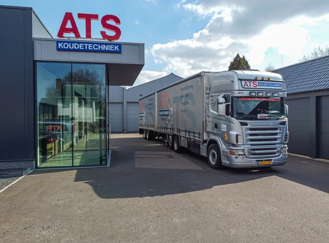 Refrigeration company premises with a truck and trailers lined up at the office entrance